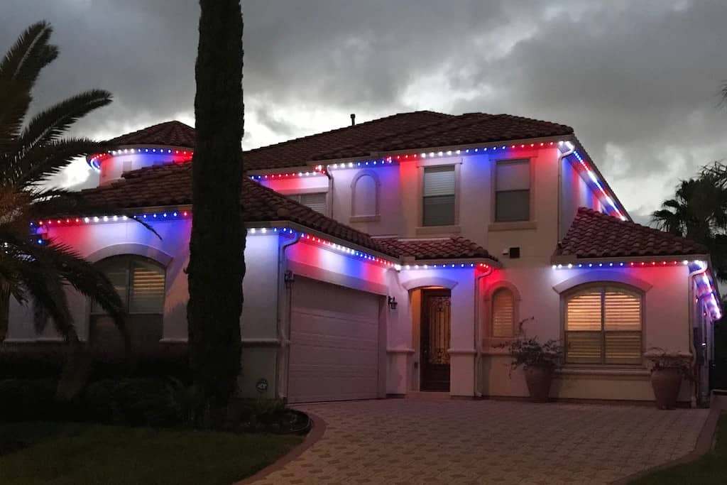 Trimlights installed on house with red, white, and blue pattern